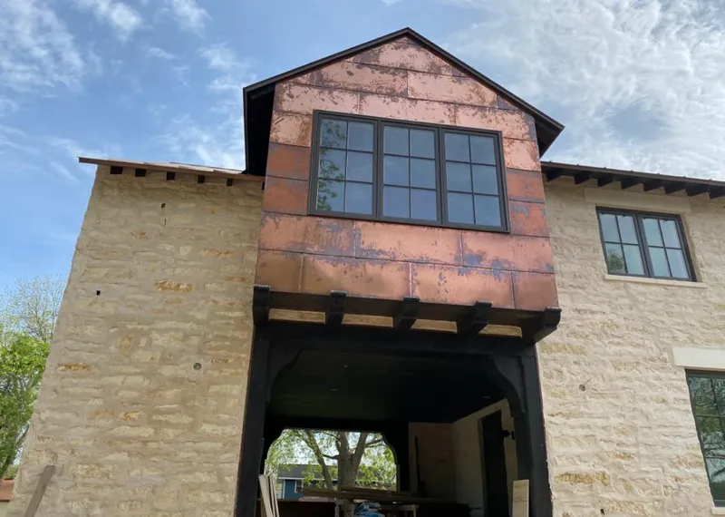 Copper metal panel facade on a stone building for Skylight Installation in Shady Hills