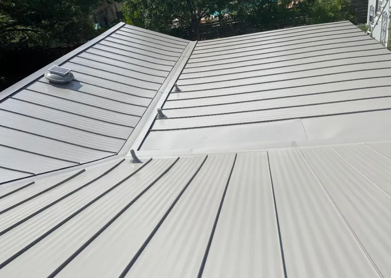 Solar attic fan installed on a metal roof for Roof Ventilation in Shady Hills